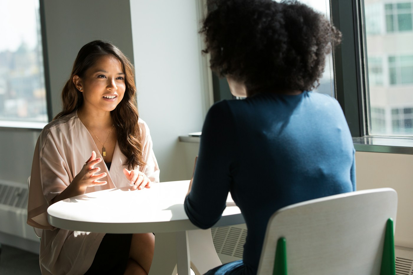 Two women having a personal conversation at a table